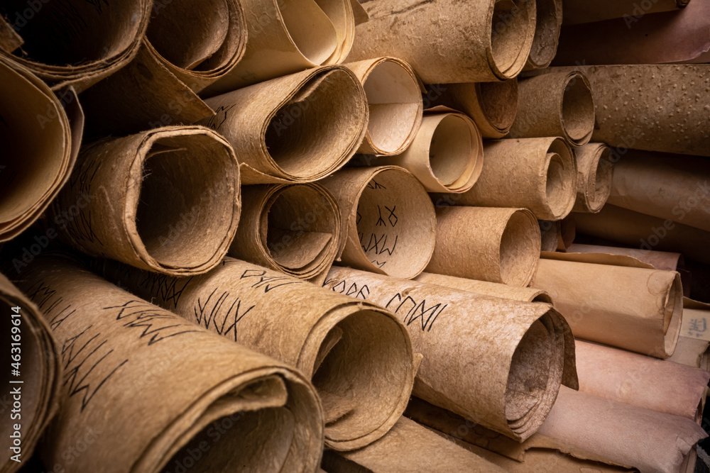 Ancient scrolls stacked on pile. Old scroll library. Stock Photo