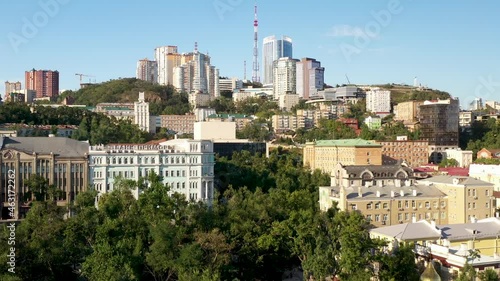 A flight above the city Vladivostok above buildings, bridges, embankment and ships