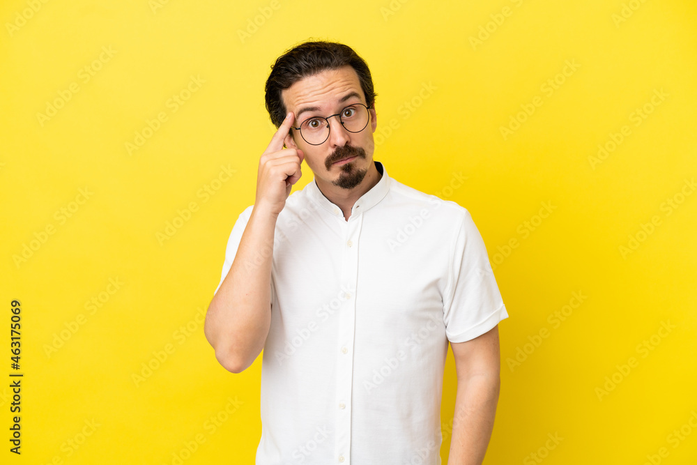 Young caucasian man isolated on yellow background thinking an idea Young caucasian man isolated on yellow background thinking an idea