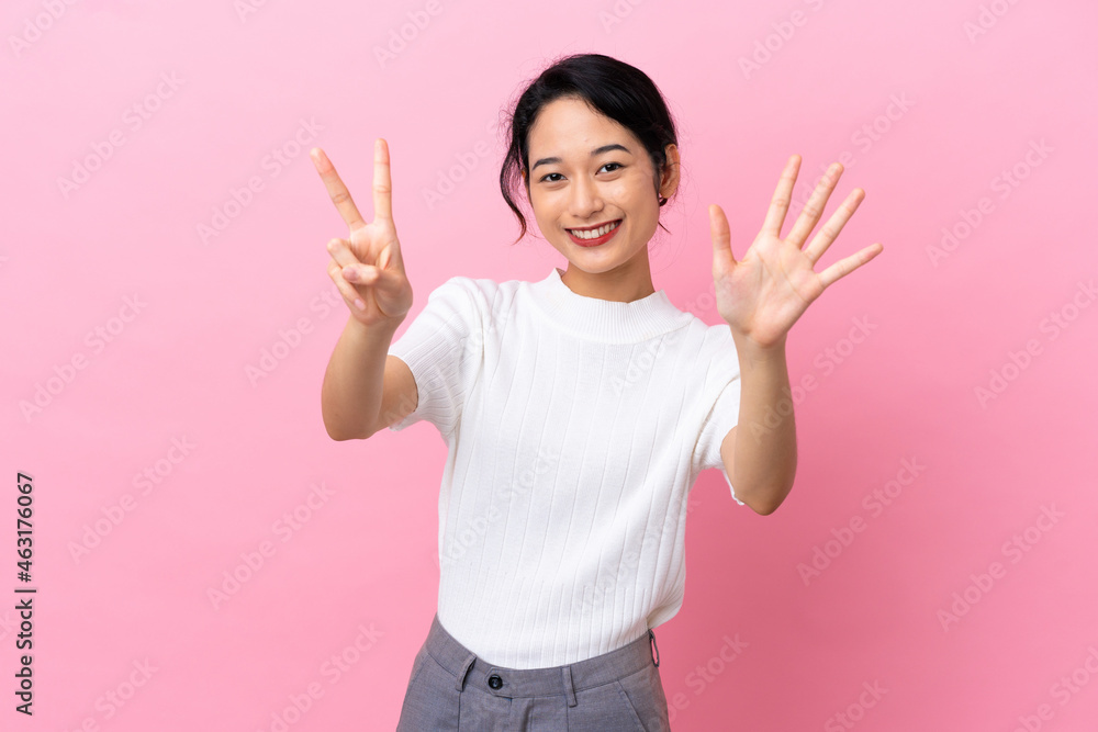 Young Vietnamese woman isolated on pink background counting seven with fingers Young Vietnamese woman isolated on pink background counting seven with fingers