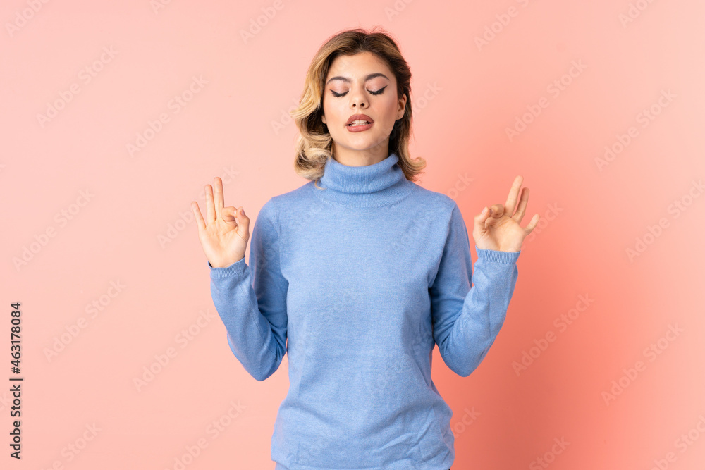 Young Russian woman isolated on pink background in zen pose Young Russian woman isolated on pink background in zen pose