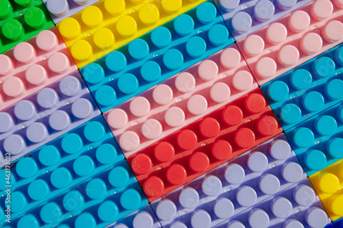 children s play background  the plane of plastic multi-colored bricks  blur  selective focus