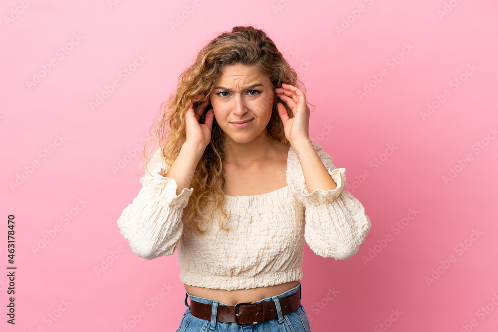 Young blonde woman isolated on pink background frustrated and covering ears Young blonde woman isolated on pink background frustrated and covering ears