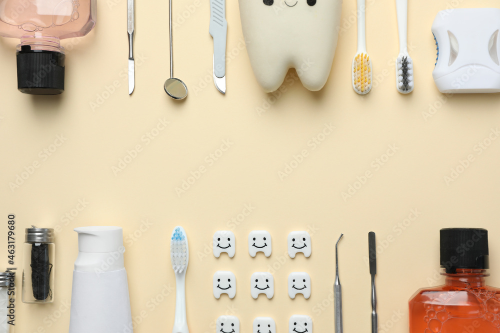 Plastic teeth with cute faces, oral care products and dental tools on beige background, flat lay. Space for text - obrazy, fototapety, plakaty 