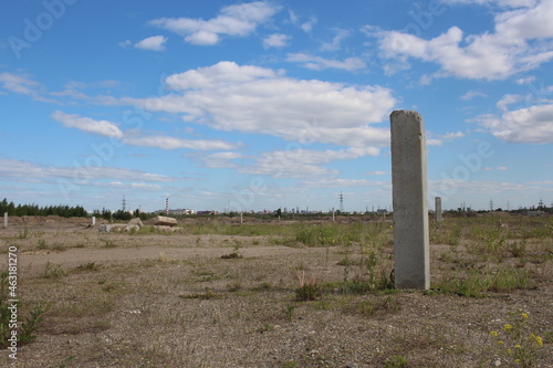 concrete foundation pillar on a vacant lot construction industrial site
