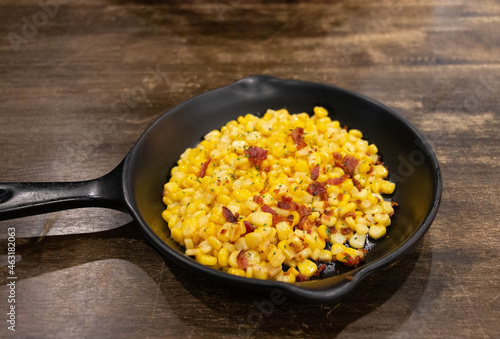 sweet buttered corn with ham in rustic pan