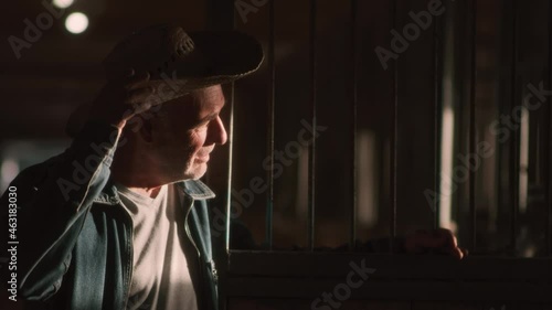 The farmer takes off his hat and looks at the sunlight