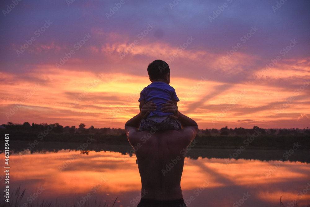 silhouette of father and son at sunset happy life