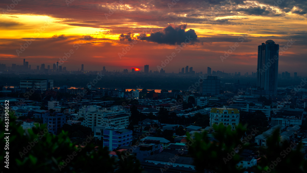 Fototapeta premium The blurred abstract background of the morning sun exposure to the tiny dust particles that surround the tall buildings in the capital, the long-term health issue of pollution.