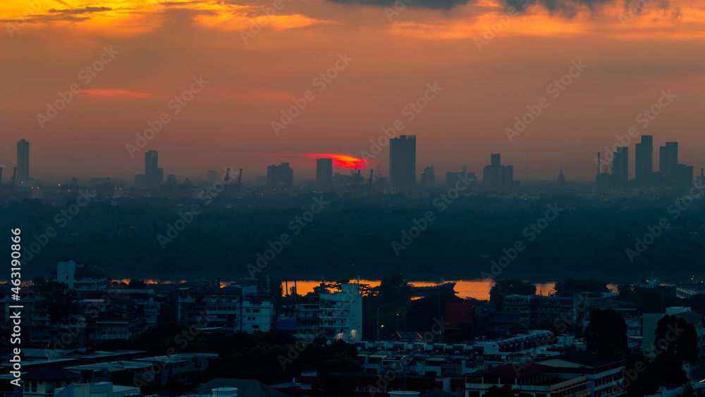 The blurred abstract background of the morning sun exposure to the tiny dust particles that surround the tall buildings in the capital, the long-term health issue of pollution.