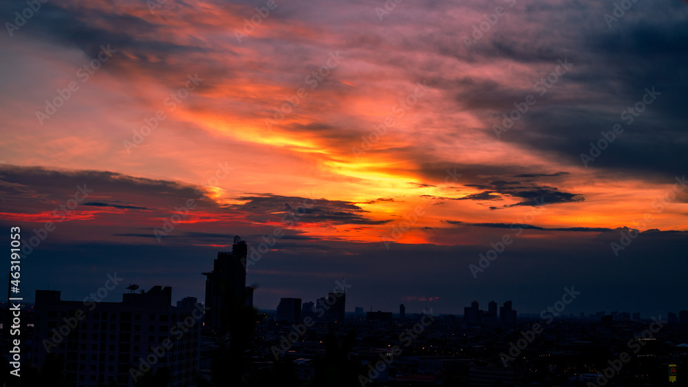 The blurred abstract background of the morning sun exposure to the tiny dust particles that surround the tall buildings in the capital, the long-term health issue of pollution.