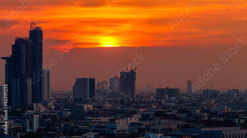 The blurred abstract background of the morning sun exposure to the tiny dust particles that surround the tall buildings in the capital, the long-term health issue of pollution.