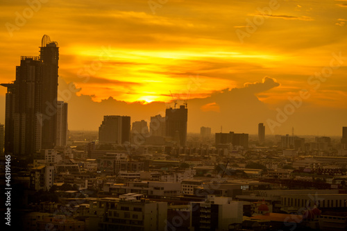 The high angle background of the city view with the secret light of the evening, blurring of night lights, showing the distribution of condominiums, dense homes in the capital community