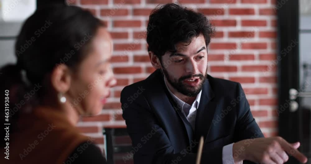 Diverse people, Latin American businesswoman and caucasian man, sit and working together in office. Diversity colleagues discuss idea with laptop computer with intimate and professional team action. Diverse people, Latin American businesswoman and caucasian man, sit and working together in office. Diversity colleagues discuss idea with laptop computer with intimate and professional team action.