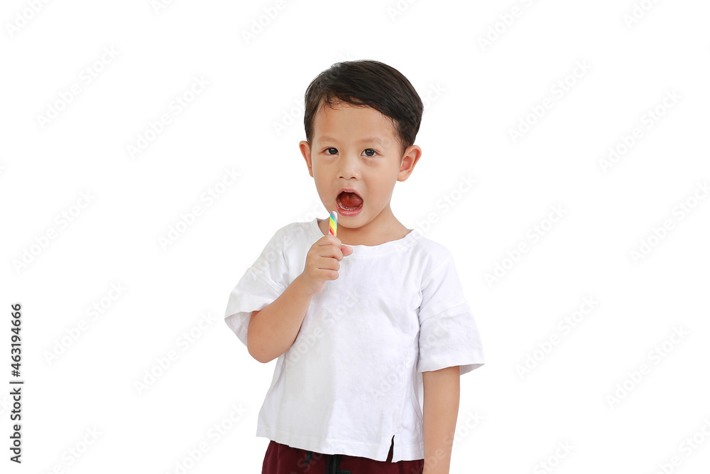 Asian little boy eating lollipop candy isolated on white background. Image with clipping path Asian little boy eating lollipop candy isolated on white background. Image with clipping path
