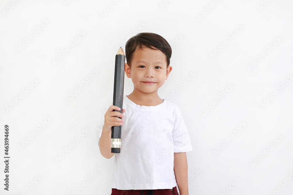 Adorable Asian little boy holding big pencil and looking camera over white background. Kid and education concept Adorable Asian little boy holding big pencil and looking camera over white background. Kid and education concept