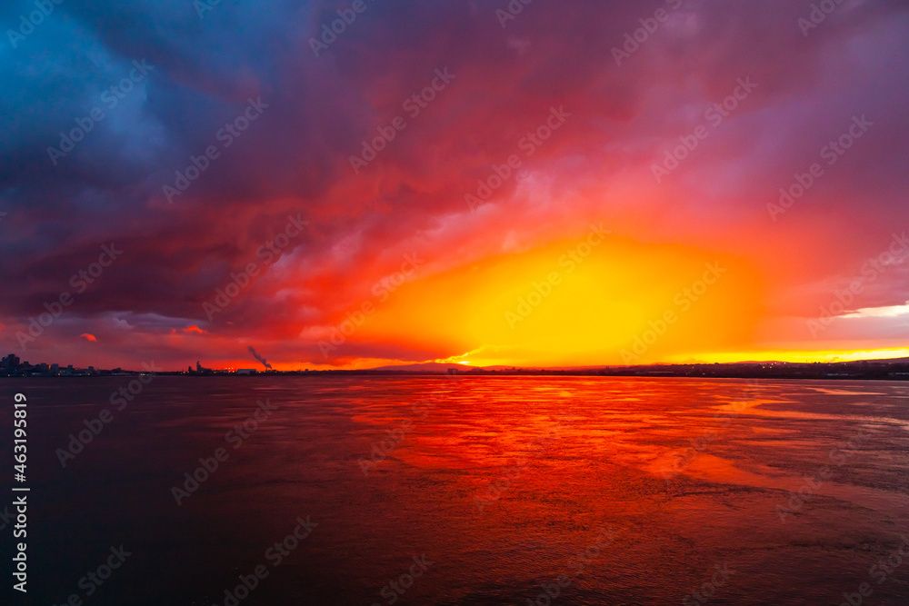 Sunset from the sea bay with red-orange-blue sky.