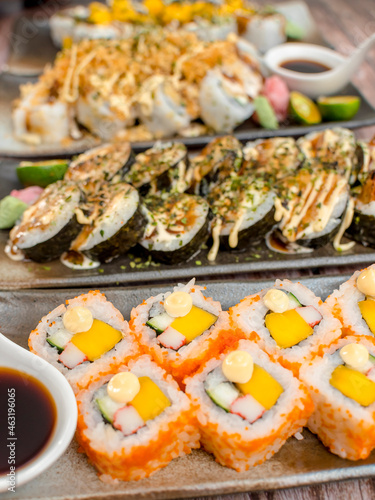 Various makizushi rolls - California, Spicy shrimp, Tempura and other flavors. photo