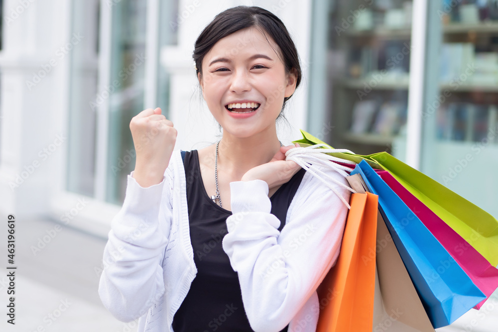 Happy excited woman shopping in neighborhood shopping mall Happy excited woman shopping in neighborhood shopping mall