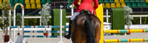 Rider and horse in jumping show. Beautiful girl on sorrel horse in jumping show, equestrian sports. Light-brown horse and girl in uniform going to jump. Horizontal web header or banner design.