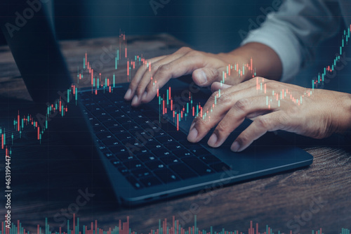 Businessman working stock traders making analysis of digital market and investment, technical chart red and green and laptop screen background for stock trading.