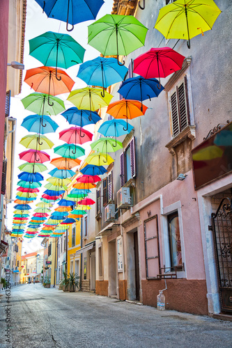 Street in Novigrad decorated with umbrellas © zlatkozalec