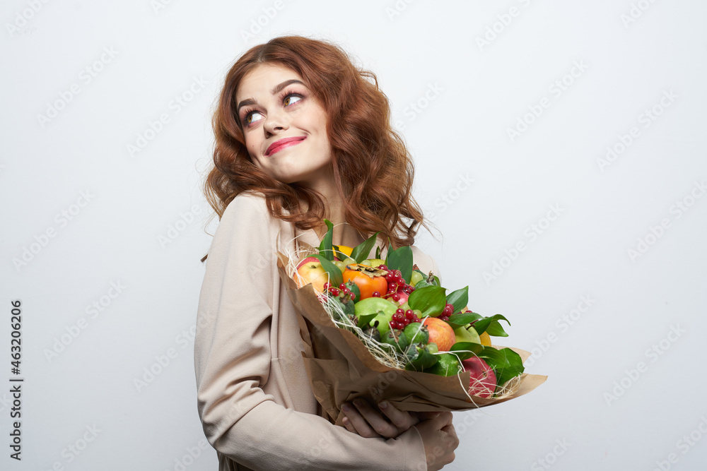 portrait of a woman fun posing fruit bouquet vitamins light background portrait of a woman fun posing fruit bouquet vitamins light background