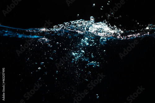 Water Surface with Ripple and Bubbles on Black Background. Water Wave 
