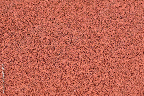 Texture of a rubber crumb for stadium. Rubber asphalt. Resilient coating for sports and athletics fields, jogging, running track and cycling paths