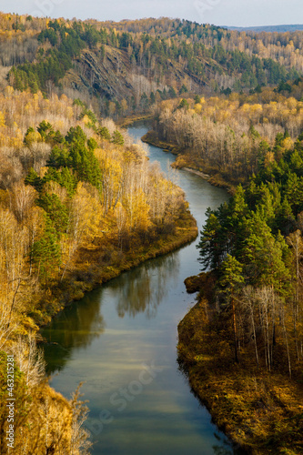 Fototapeta Naklejka Na Ścianę i Meble -  There is a beautiful place called Berdsk cliffs or Berdskie skaly in the Novosibirsk region. Rocks in these places are composed of igneous rocks. Top view of Berdsk river bend, autumn forest. Vertical
