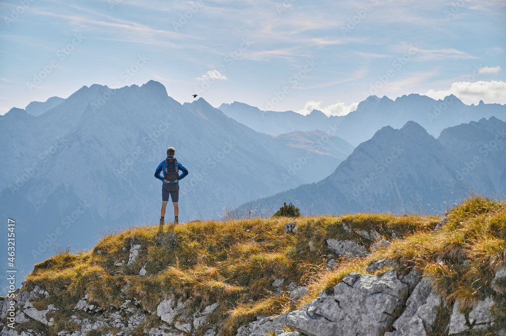 custom made wallpaper toronto digitalMan on top of a mountain in autumn, Karwendel mountains, Tirol, Austria