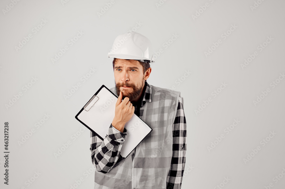 engineer in a white helmet blueprints Professional studio industry engineer in a white helmet blueprints Professional studio industry