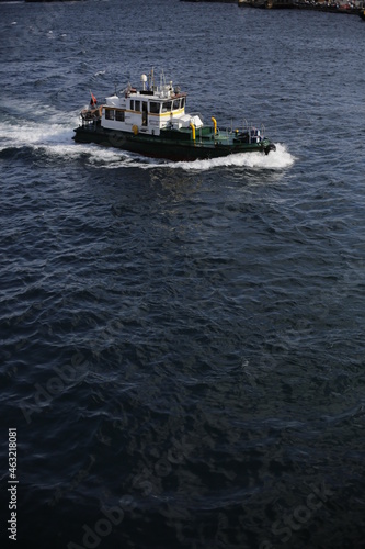 A tour on the coast of the Bosphorus in Istanbul - Turkey Boats and tourists on the Galata Bridge and Galata Tower and fishermen. Seagulls are flying, an old man and his wife are back watching the sun