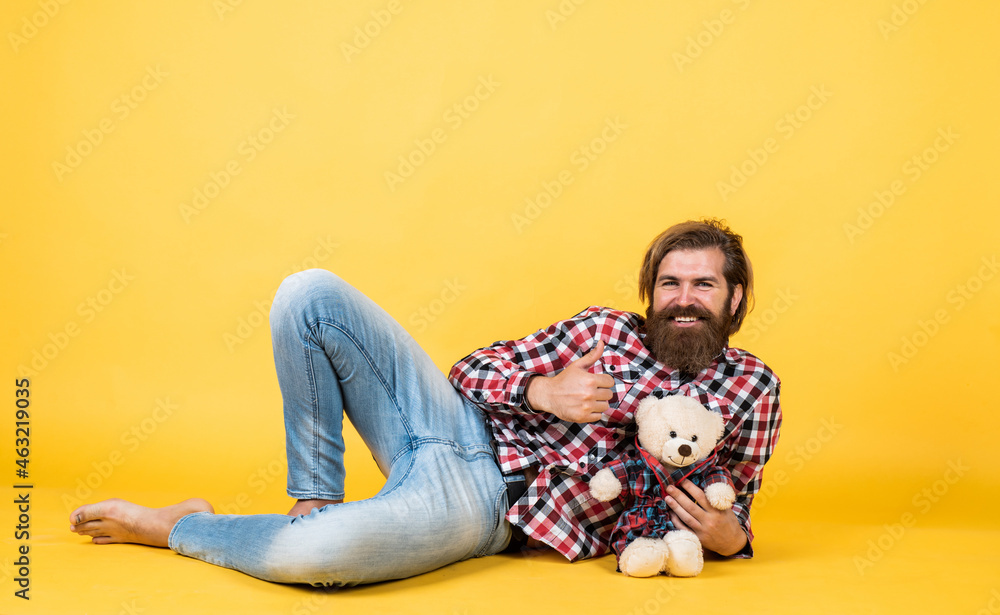 time to relax. happy birthday. being in good mood. happy valentines day. cheerful bearded man hold teddy bear. male feel playful with bear. brutal mature hipster man play with toy time to relax. happy birthday. being in good mood. happy valentines day. cheerful bearded man hold teddy bear. male feel playful with bear. brutal mature hipster man play with toy