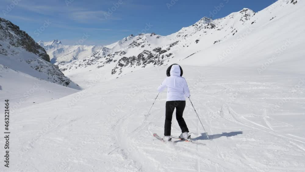 Skier Skiing Down Slalom On Snowy Hillside In Mountains In Winter On Ski Resort Skier Skiing Down Slalom On Snowy Hillside In Mountains In Winter On Ski Resort