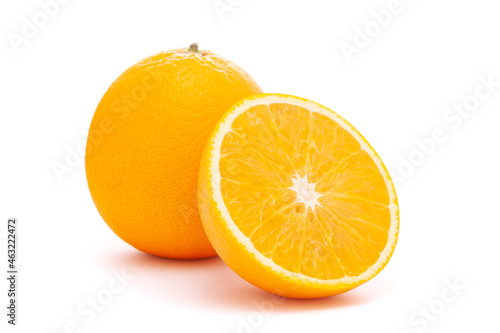 Close-up of Organic Indian Citrus fruit sweet  Seedless kinnow (Kinnow mandarin) high yield mandarin hybrid with its half cut, it is yellow in color, isolated over white background, photo