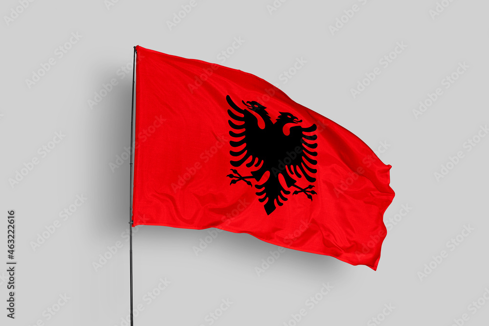 Albania flag isolated on the blue sky background. close up waving flag of Albania. flag symbols of Albania. Concept of Albania. Albania flag isolated on the blue sky background. close up waving flag of Albania. flag symbols of Albania. Concept of Albania.
