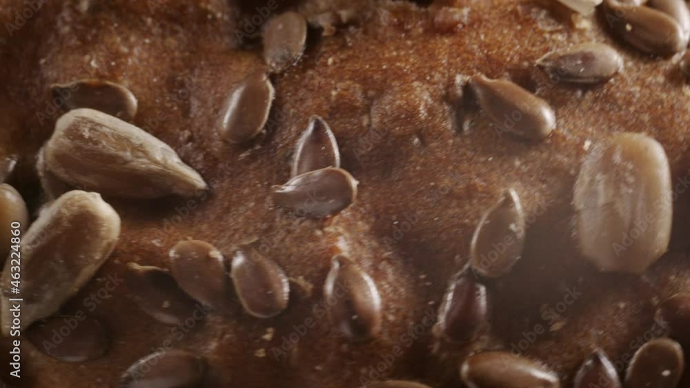 Macro shooting of rotating bread with flax and sunflower seeds Macro shooting of rotating bread with flax and sunflower seeds