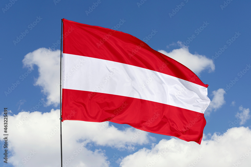Austria flag isolated on the blue sky background. close up waving flag of Austria. flag symbols of Austria. Concept of Austria. Austria flag isolated on the blue sky background. close up waving flag of Austria. flag symbols of Austria. Concept of Austria.