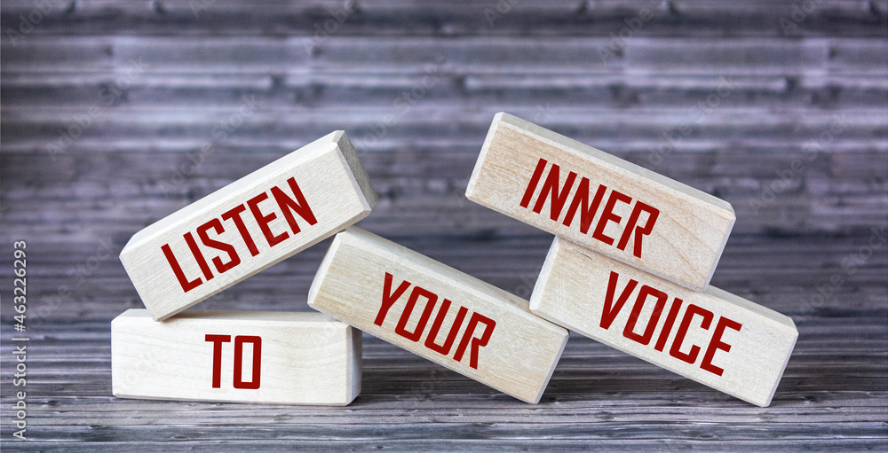 Listen to your inner voice - the text is written on wooden blocks that lie on a wooden background. - obrazy, fototapety, plakaty 