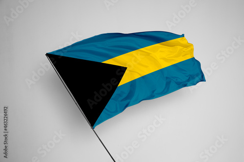 Bahamas flag isolated on white background. close up waving flag of Bahamas. flag symbols of Bahamas. Concept of Bahamas.