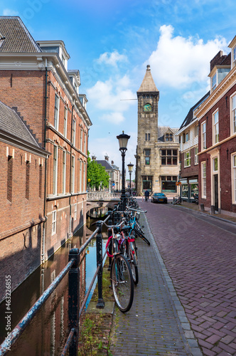 Typical Amsterdam canals with bridges and colorful boat, Netherlands, Europe