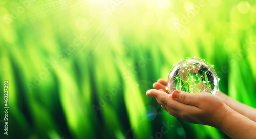 Fototapeta Naklejka Na Ścianę i Meble -  Global communication network. Hands holding crystal earth globe and circle global network connection.Energy and ecology concept. Protecting earth planet  and development ecological energy