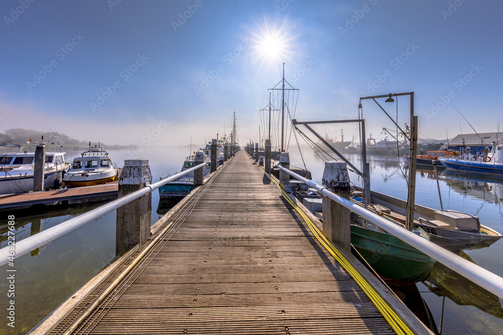 Various ships moored on a wooden quay