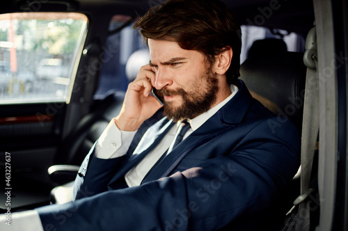 emotional man in a suit in a car a trip to work success service rich