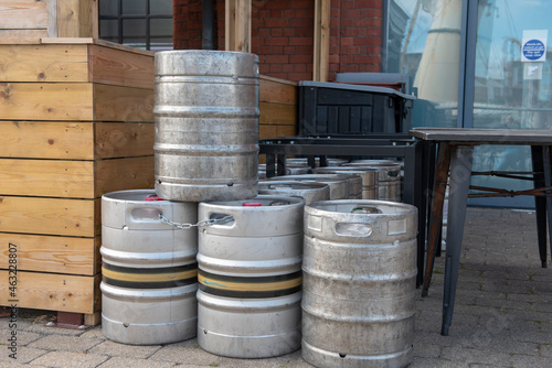 Stack of metal beer barrels outdoors 