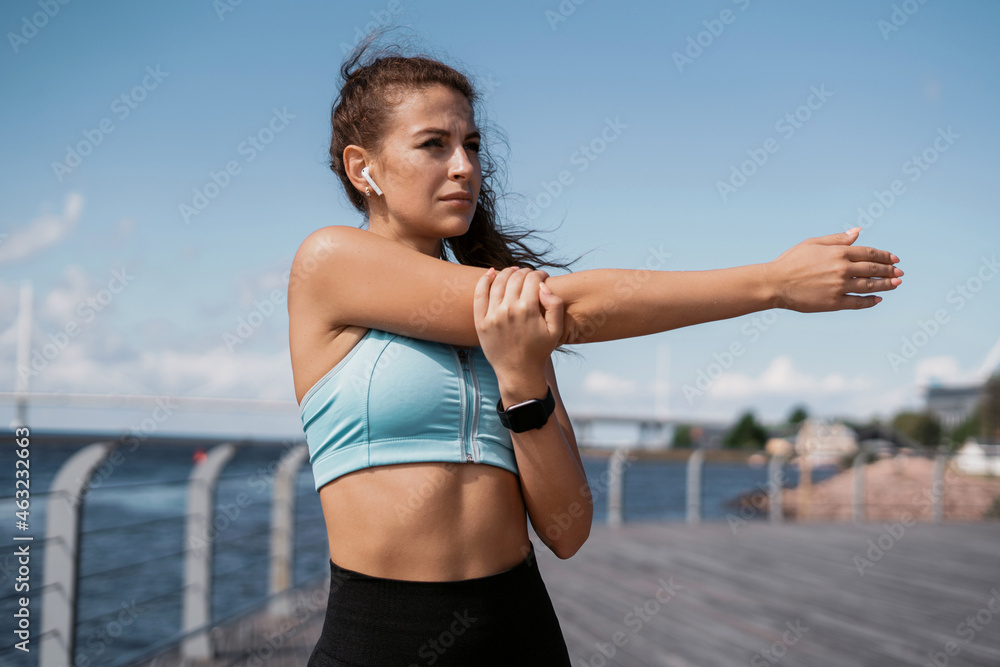 Fitness cardio workout on the street in the city. Smart watch heart rate measurement. Health and lifestyle. Portrait of a woman exercising and running. The trainer is a marathon for a distance. Fitness cardio workout on the street in the city. Smart watch heart rate measurement. Health and lifestyle. Portrait of a woman exercising and running. The trainer is a marathon for a distance.