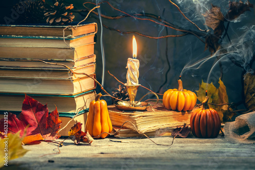 Old antique books with pumpkin shape candles