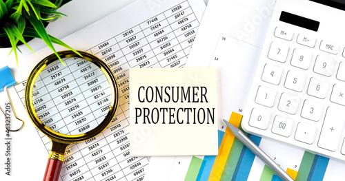 CONSUMER PROTECTION text on sticker on diagram with magnifier and calculator. Business concept