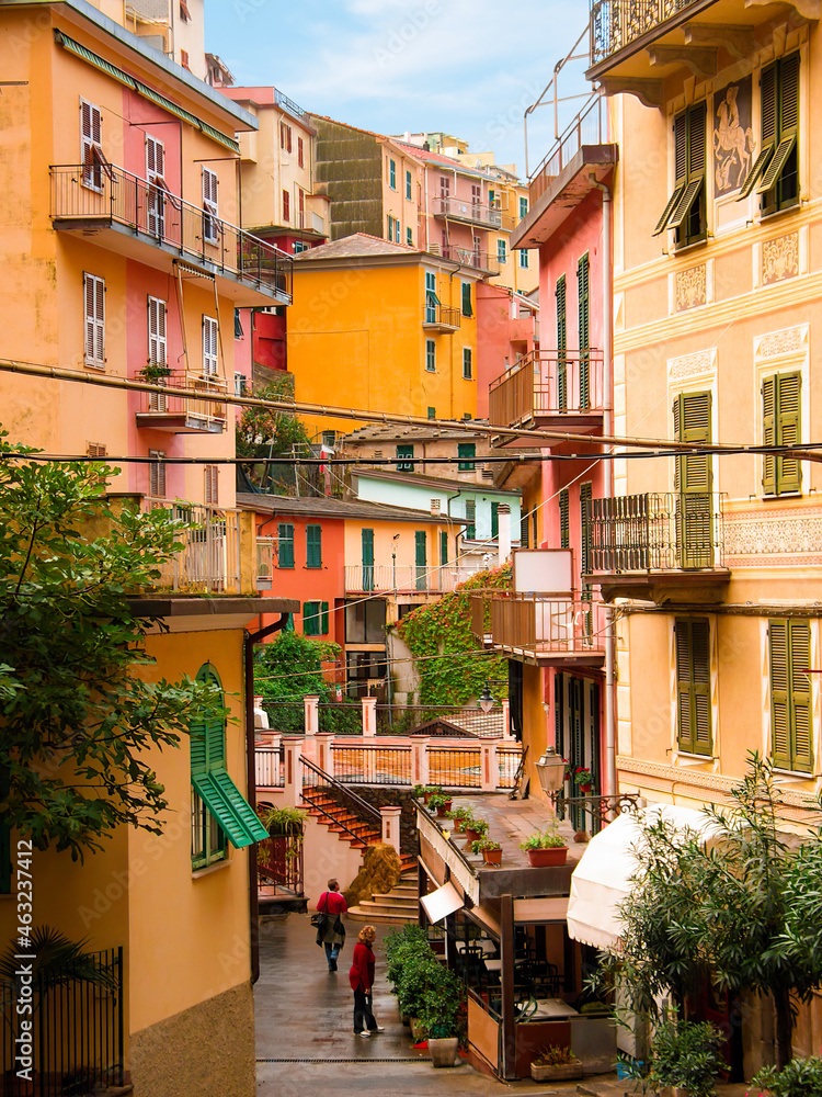 Charming colourful houses overlook the street and alley in Manarola a picturesque village in the Cinque Terre, Italy. This famous UNESCO site is popular with tourists